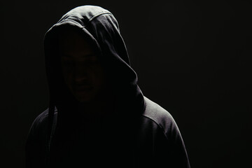 Silhouette of hooligan in hoodie isolated on black - obrazy, fototapety, plakaty