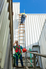 Engineering or worker descended the fire escape to the safe zone. Man in Fire escape to the roof. Worker climbing down fire escape ladder