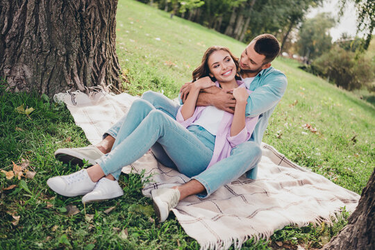Photo of pretty charming husband wife dressed casual clothes embracing sitting grass enjoying sunshine outside backyard