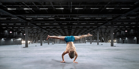 Young athlete standing in a handstand
