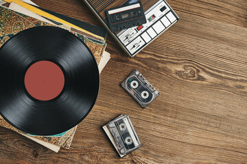 Vinyl records, cassette tapes and cassette recorder. Retro music style. 80s music party. Vintage...