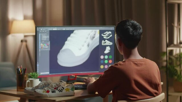 Asian Boy Footwear Designer Celebrating Succeed Designing Shoe On A Desktop At Home. Shoe Production Procedure Concept&nbsp;
