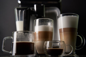 Group of cup with different freshly types of coffee: cappuccino, latte and espresso.