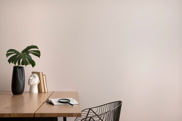 The stylish composition of cozy office interior with copy space, metal chair, wooden table and...