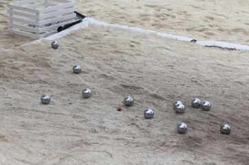 petanque, game with steel balls on the sand
