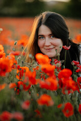 Naklejka premium Scenic picturesque of beautiful girl in white and beige dress and straw hat in poppy field at sunset, Portrait of romantic young woman with flowers, body positivity, Selective focus natural light