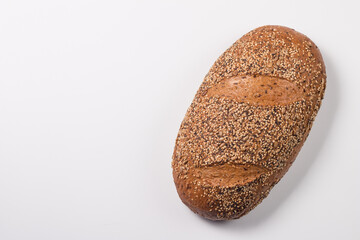 Fresh bread with seeds on a white table background. Bakery. Food security concept. 