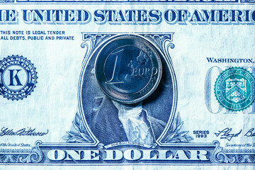 one euro coin on a one US dollar bill