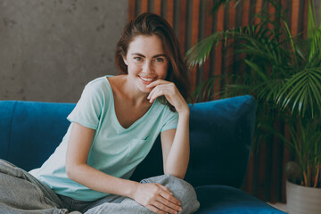 Young happy smiling satisfied positive woman she 20s wearing casual clothes mint t-shirt look...