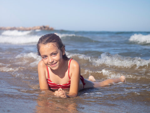Portrait Of Little girl on the beach. Vacational concept. 