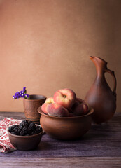 still life with peaches and blackberries, done in brown tones
