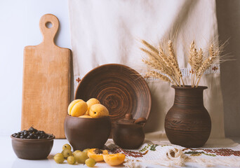 Still life with apricots and flowers shot in ethno style
