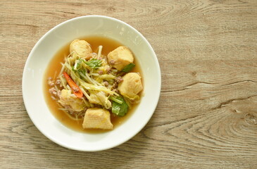 fried white garlic chive with slice yellow egg tofu and chop pork on plate