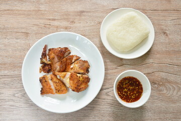 grilled slice chicken wing on plate dipping with spicy sauce