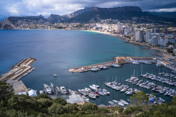 view from above of a small port in the Mediterranean Sea and hotels with mountains in the background Calpe city