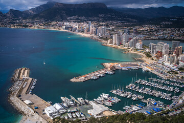 view from above of a small port in the Mediterranean Sea and hotels with mountains in the background Calpe city