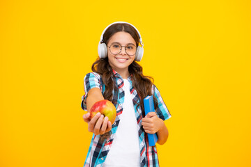 School and education concept. Back to school. Schoolchild, teenage student girl with bagpack hold apple and book.