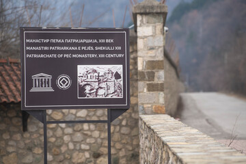 Table sign and Entrance gate to Medieval Monastery and Church Pecka Patrijarsija, main Serbian...