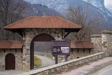 Table sign and Entrance gate to Medieval Monastery and Church Pecka Patrijarsija, main Serbian orthodox monastery and patriarchate. UNESCO world heritage site in Pec, Kosovo, Serbia 05.03.2022