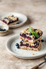 Homemade blueberry crumble bars on a plate decorated with mint. Healthy homemade food concept