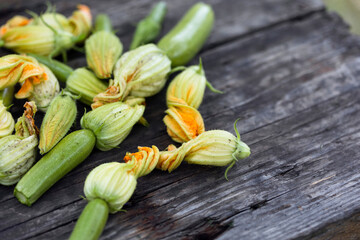 zucchini with flowers on a wooden background