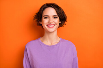 Portrait of satisfied glad young person toothy beaming smile look camera isolated on orange color...