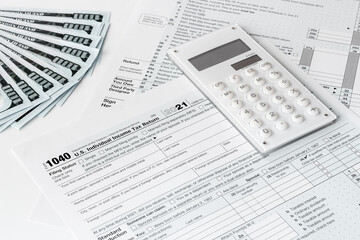 Obraz premium Annual tax form under US law with money cash. Tax payment season