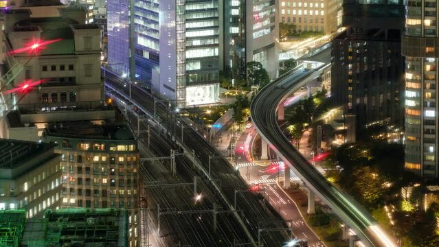 Time lapse aerial view zoom in of sky train traffic running in downtown at Daimon