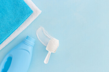 Fototapeta premium White washing powder with towels and a laundry conditioner bottle