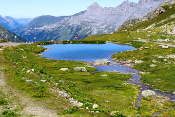 Beautiful scenic view of mountain panorama with mountain lake at Swiss mountain pass Susten on a sunny summer day. Photo taken July 13th, 2022, Susten Pass, Switzerland.