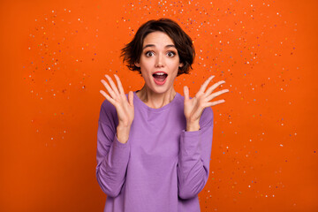 Portrait of astonished satisfied lady raise opened hands palms isolated on orange color background
