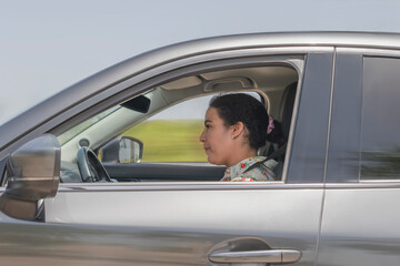 Side shot of woman driving a car