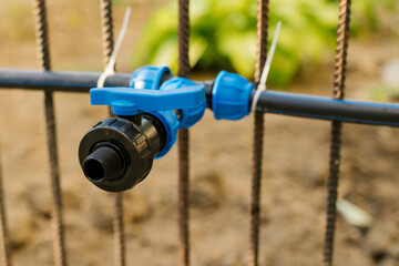 Irrigation equipment. Pipe connection using a compressor coupling. Drip irrigation in the garden. A...