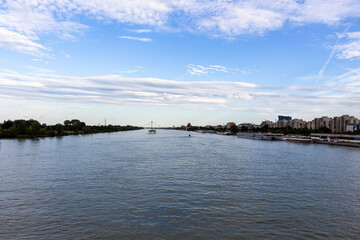 VIENNA, AUSTRIA - August 17, 2019: Beautiful blue Danube river near the Imperial bridge with boats in the distance