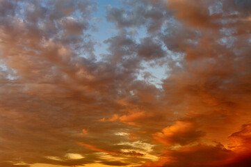 Sunset sky landscape, the sun painted the clouds in orange and red, dramatic sky, beautiful natural texture