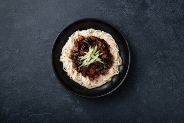 Jajangmyeon on a concrete background, top view