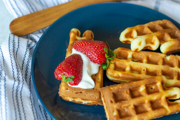 Belgian waffles with strawberries and creamy dessert sauce