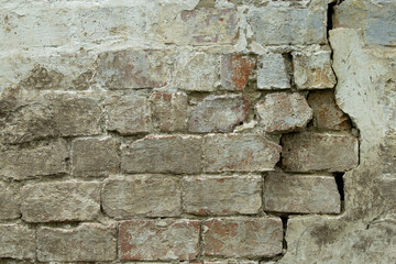 old brick wall cracked, falling apart