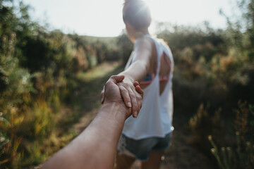 Young couple holding hands and leading