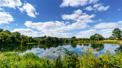 Obraz na płótnie Canvas Blue skies over Chingford Pond.