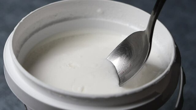 slow motion of pick fresh yogurt with a spoon 