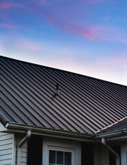 a beautiful house metal roof during the sunset