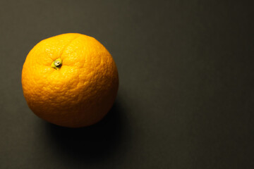 Close up view of orange on black background.