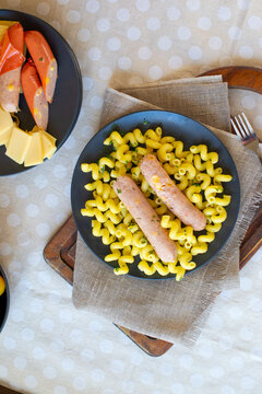 Boiled cheese sausages with cellentani garnish