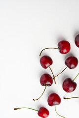 Obraz na płótnie Canvas Sweet red cherries isolated on white background, fresh cherries with stems and leaves. Copy space. Food and fruit concept.
