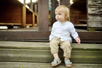 Funny toddler boy having fun outdoors on sunny summer day. Child exploring nature. © MNStudio