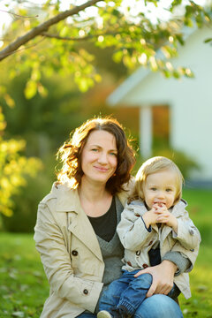 Cute Funny Toddler Boy In His Mothers Arms. Mom And Son Having Fun On Sunny Autumn Day In A Park.