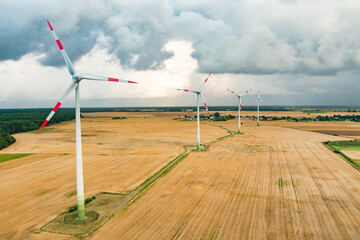 Aerial view of wind turbines generating power, located in Lithuania, on summer day.
