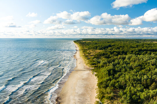 Aerial view of the Baltic Sea shore line near Klaipeda city, Lithuania. Beautiful sea coast on summer day.