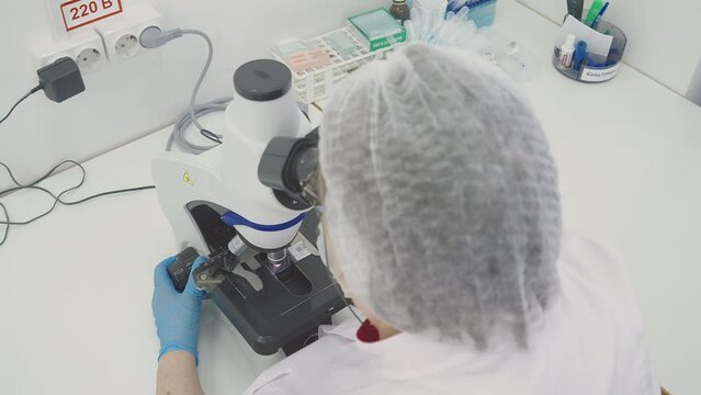 Microscopic Research Of Blood Smear In Medical Laboratory To Determine Health Disorders. Detecting Blood Diseases With Research Microscope In Laboratory. Blood Research By Doctor In Laboratory